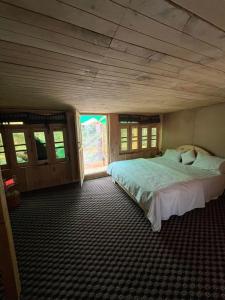 a bedroom with a large bed in a room at Kumrat Ecotourism Resort in Tāl