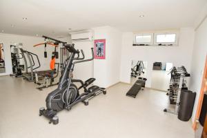 a gym with several treadmills and machines in a room at Villa Ela, Royal Links,Sarigerme in Ortaca