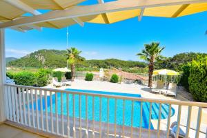 a view from the balcony of a villa with a swimming pool at Villa Ela, Royal Links,Sarigerme in Ortaca