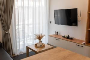a living room with a flat screen tv on a wall at Ocean-Πολυτελές διαμέρισμα στο Αγρίνιο in Agrinio
