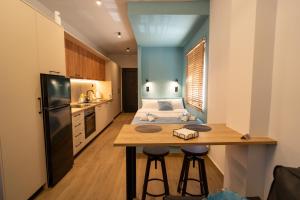 a small kitchen with a bed and a table in a room at Ocean-Πολυτελές διαμέρισμα στο Αγρίνιο in Agrinio +9 photos