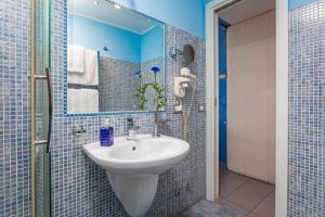 a bathroom with a sink and a mirror at Casa Mare Sea View in Giardini Naxos