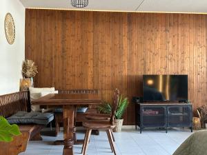 a living room with a table and a television at Ski Hide Out Engelberg, Titlis, Luzern in Engelberg