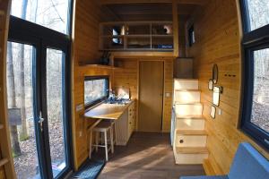a small kitchen in a tiny house with windows at POP Tiny House Mátra in Mátraszentimre