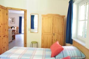 a bedroom with a bed and a wooden cabinet at Ferienwohnung Ferienhäuser am Brocken, 60 qm 2 Schlafzimmer in Ilsenburg