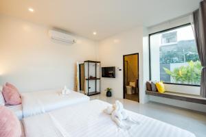 a bedroom with two beds with stuffed animals on them at Black Rocher Poolvilla Huahin in Hua Hin +58 photos