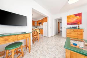 sala de estar con escritorio y TV en la pared en MarySol 5 terrace with sea views, close to the sea, en Punta Mujeres 19 fotos más