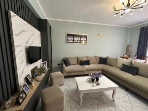 a living room with a couch and a table at Xhekle Apartment Durres in Durrës
