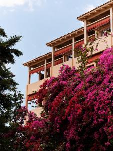 a building with pink flowers in front of it at The Margi in Athens