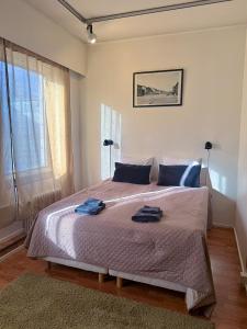 a bedroom with a bed with two towels on it at Grand Salo Hotel in Salo +15 photos