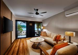 a living room with a couch and a table at The Taaras Beach & Spa Resort in Redang Island