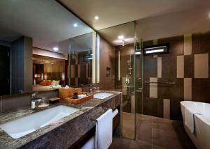 a bathroom with two sinks and a shower at The Taaras Beach & Spa Resort in Redang Island