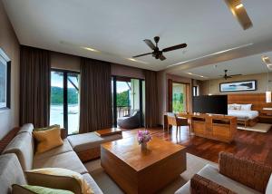 a living room with a couch and a table at The Taaras Beach & Spa Resort in Redang Island