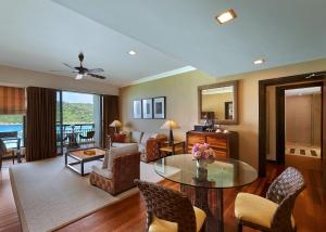 a living room with a table and some chairs at The Taaras Beach & Spa Resort in Redang Island