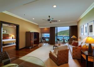 a living room with a couch and a room with a view at The Taaras Beach & Spa Resort in Redang Island