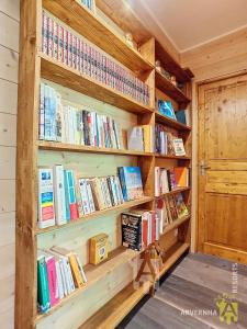 a book shelf filled with books in a room at Chalet Les Mélèzes in Chambon-sur-Lac +13 photos