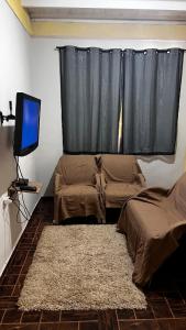 a bedroom with a bed and a television and a window at Sobrado inteligente com ótima localização in Foz do Iguaçu