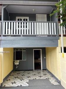 a small house with a balcony and a staircase at Sobrado inteligente com ótima localização in Foz do Iguaçu