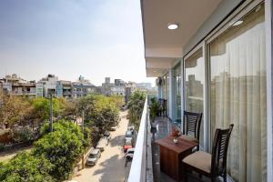 a balcony with a table and chairs and a city at Hotel The Venice- Near Indraprastha Apollo Hospital in New Delhi
