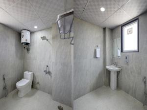 a bathroom with a toilet and a sink at Hotel The Venice- Near Indraprastha Apollo Hospital in New Delhi +18 photos