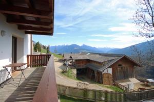a balcony of a house with a view of mountains at Aurturist Valdaora Roulette in Valdaora +18 photos