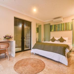 a bedroom with a large bed and a table at Villa EL Noya Umallas in Badung +6 photos