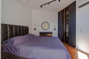 a bedroom with a large bed and a mirror at Sunshine Appartement Budva in Bečići +35 photos