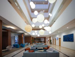 a lobby with couches and chairs and lights at Zephyr Agadir in Agadir
