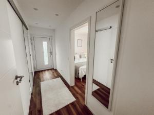 a hallway with a mirror and a bedroom with a bed at Ferieneleganz am Fluss in Bad Ems