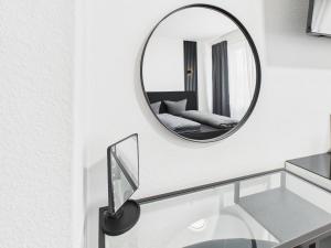 a bathroom with a mirror and a glass sink at Loft & Living am Geiseltalsee in Braunsbedra