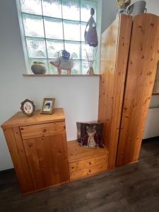 Habitación con armario de madera y ventana. en Winzerhäuschen Kern, en Fehring