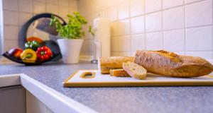 a loaf of bread on a cutting board on a kitchen counter at Haus Sonneneck 1 in Bad Zwischenahn