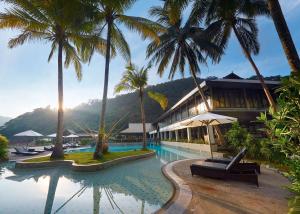 a resort with palm trees and a swimming pool at The Taaras Beach & Spa Resort in Redang Island