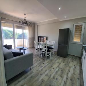 a living room with a couch and a table at Urban Charm Lalzi in Draç