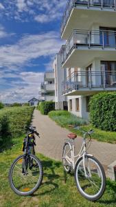 a bike parked in the grass next to a building at Osiedle Morskie in Pogórze