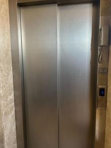 a metal elevator in a bathroom with a phone at Center Hotel Two in Istanbul