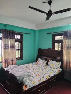 a bedroom with a bed with blue walls and windows at New aamos guest house and khaja ghar in Rāmechhāp
