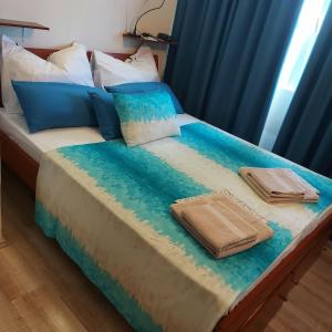 a bed with two towels sitting on top of it at Holiday house with a parking space Drvenik , Drvenik - 24088 in Dolići