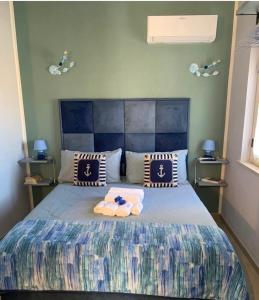 a bedroom with a bed with two towels on it at La Rosa Blu in Gerace +31 photos
