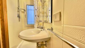 a white sink in a bathroom with a window at San Rocco in Venice +11 photos
