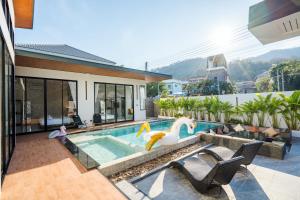 a house with a swimming pool with a pool toy at Black Rocher Poolvilla Huahin in Hua Hin