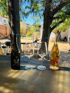 two wine glasses and a bottle on a table at Bird Song in Roodepoort