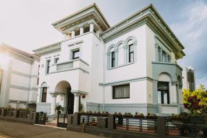 普洛耶什蒂维哥酒店的一座白色的房子,前面有大门