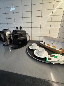 a table with two cups and a box of donuts at Casa Dolce Casa in Valencia