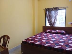 Postel nebo postele na pokoji v ubytování Rukmini Guest House