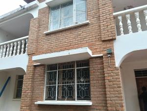 a window on the side of a brick building at Kabila moja hostel in Iringa