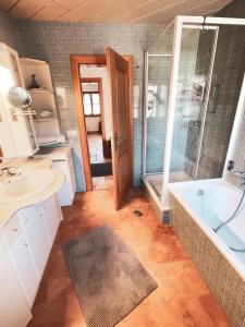 a bathroom with a tub and a sink and a shower at Ferienwohnungen Kaiser Franz in Krün +26 photos