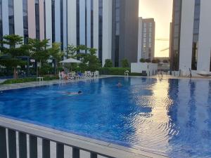 a large swimming pool in a city with tall buildings at Snazzy Studio, Cozy & Exquisite in Sharjah
