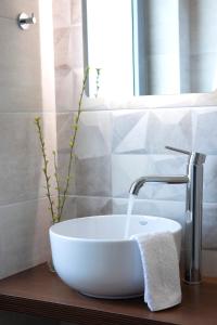 a bathroom with a white sink and a faucet at Villa Margarita in Pinakokhórion +38 photos