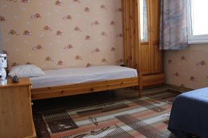 a bedroom with a bed in a room with a window at Апартаменти Амфора in Pomorie